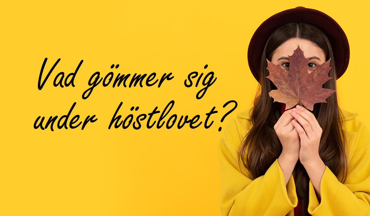 En flicka som gömmer sig bakom ett höstlöv.